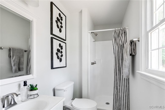 full bathroom with vanity, toilet, and a shower stall