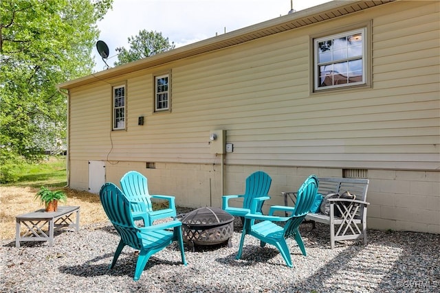 back of property with a fire pit and crawl space