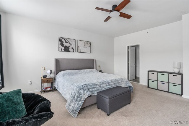 carpeted bedroom featuring baseboards and ceiling fan