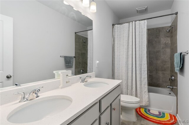 full bath featuring toilet, visible vents, a sink, and shower / bath combo with shower curtain