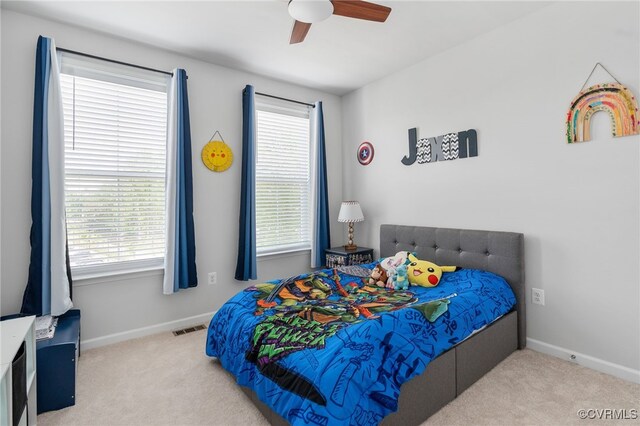 bedroom featuring baseboards, carpet flooring, and visible vents