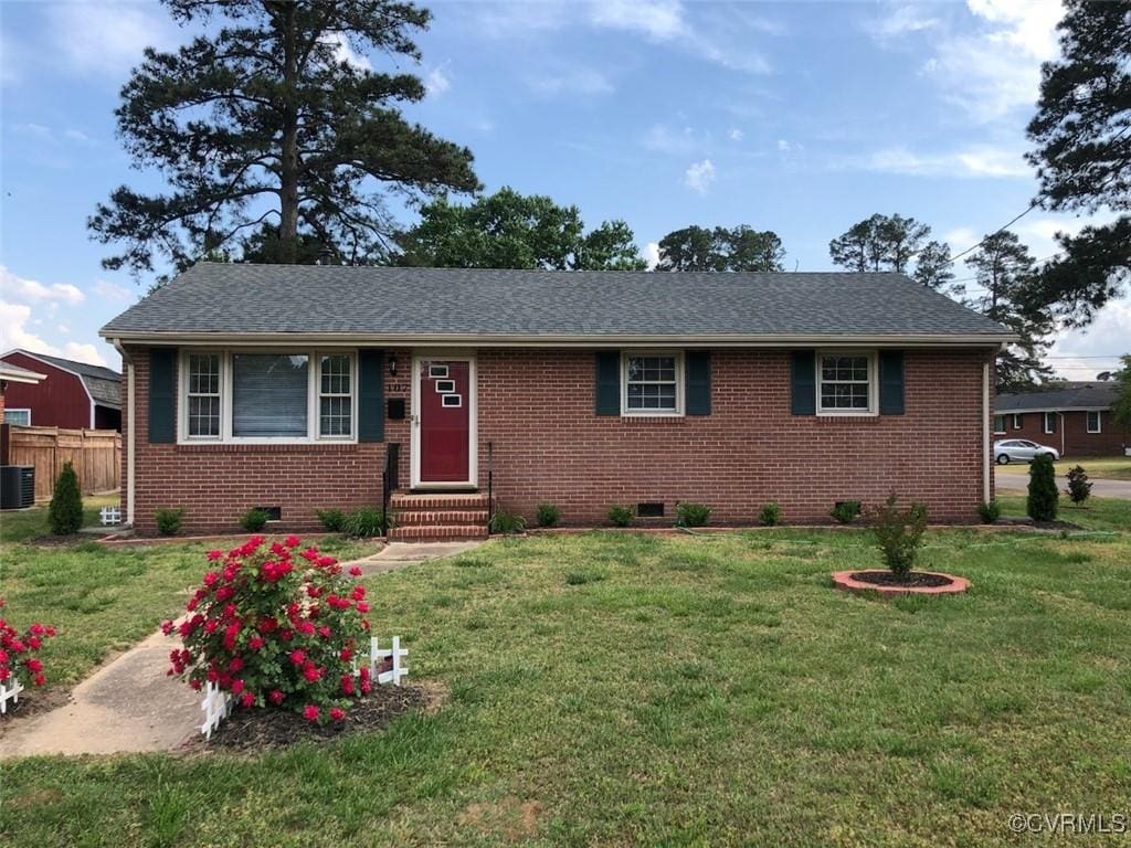 ranch-style house featuring entry steps, cooling unit, a front yard, and brick siding