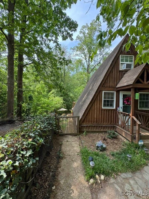 exterior space with roof with shingles and cooling unit