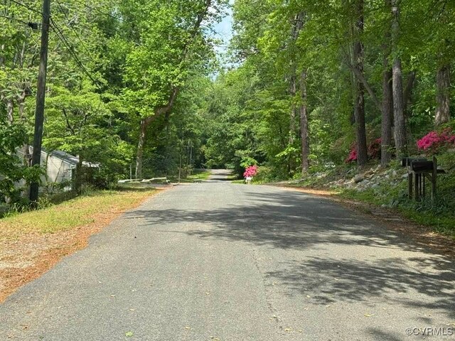 view of road featuring a forest view