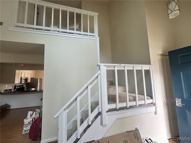 staircase featuring wood finished floors