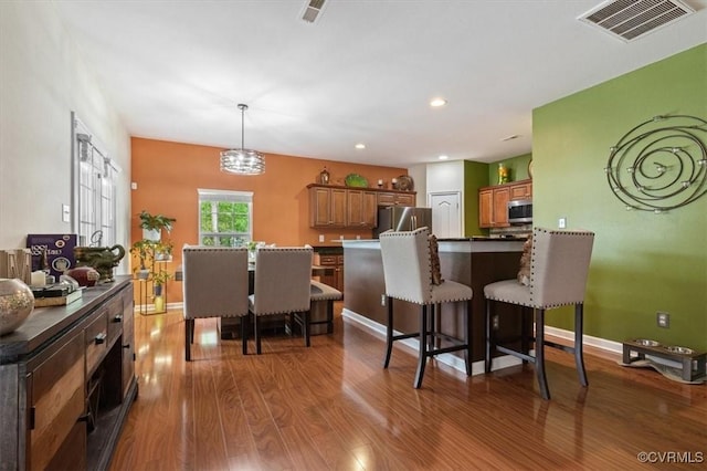 dining space featuring visible vents, recessed lighting, baseboards, and wood finished floors