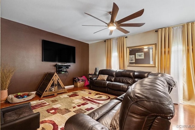 living room with ceiling fan and wood finished floors