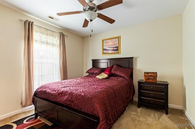 carpeted bedroom with baseboards, ceiling fan, and visible vents