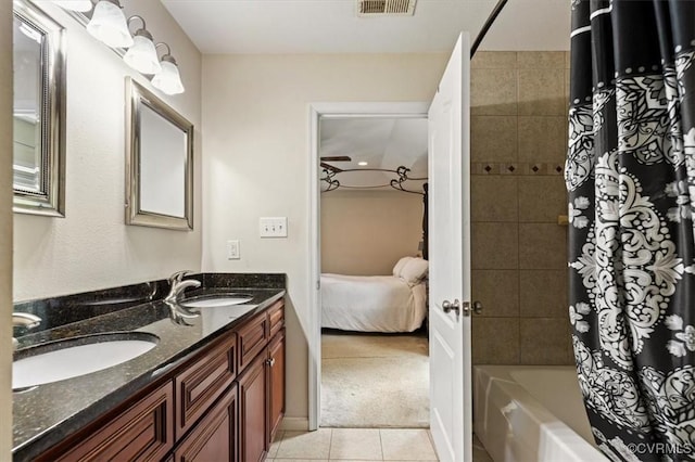 ensuite bathroom featuring a sink, tile patterned floors, ensuite bath, and shower / tub combo