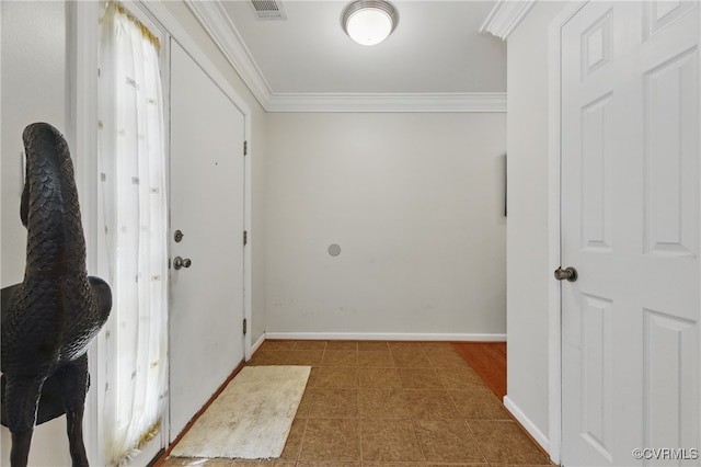 interior space featuring baseboards, visible vents, and ornamental molding