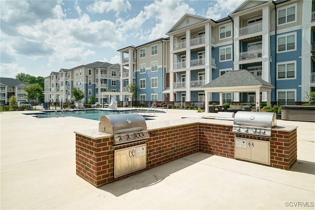 view of patio with grilling area, area for grilling, and a residential view