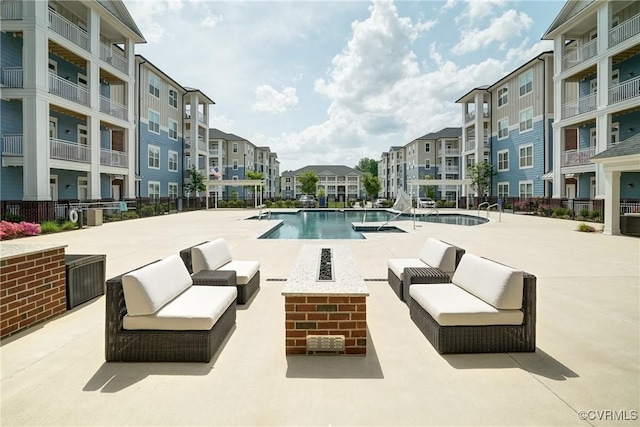 community pool featuring a patio, an outdoor living space, and a residential view