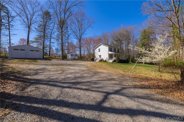 view of yard featuring a garage and an outdoor structure