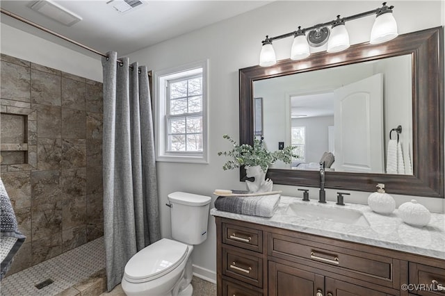 full bath featuring visible vents, vanity, baseboards, toilet, and tiled shower