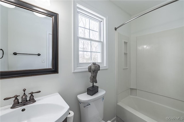 full bathroom featuring toilet,  shower combination, and a sink