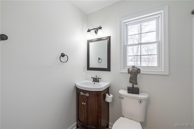 half bathroom featuring vanity and toilet