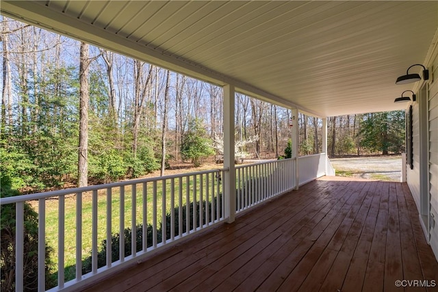 wooden deck with a lawn