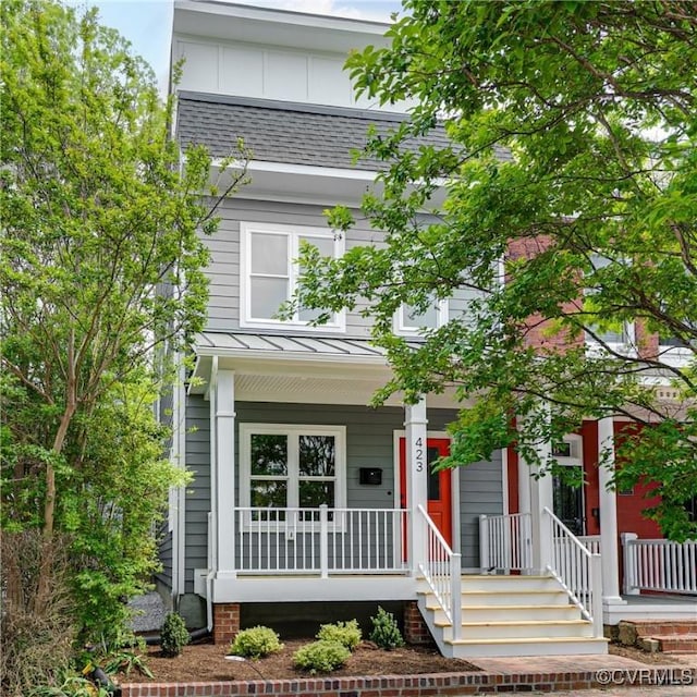 view of front of home featuring a porch, roof with shingles, and a standing seam roof
