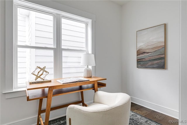 interior space with baseboards and wood finished floors