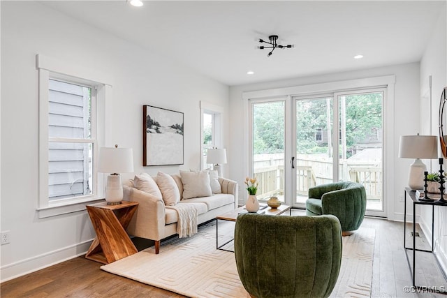 living area with a healthy amount of sunlight, baseboards, recessed lighting, and wood finished floors