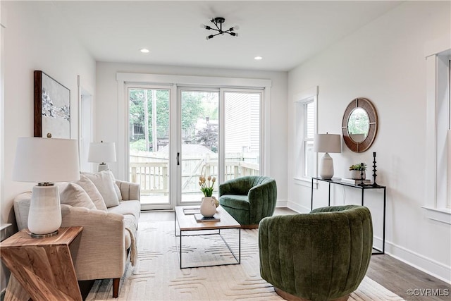 living area featuring recessed lighting, baseboards, and wood finished floors