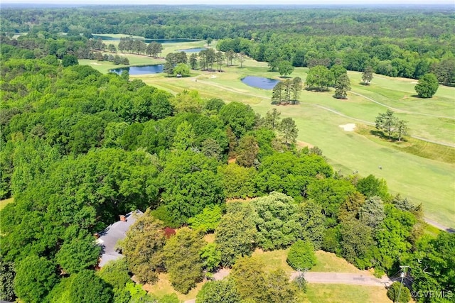 bird's eye view with a water view, view of golf course, and a wooded view