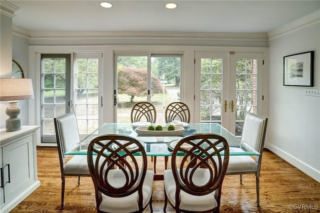 dining area featuring plenty of natural light, ornamental molding, french doors, and recessed lighting