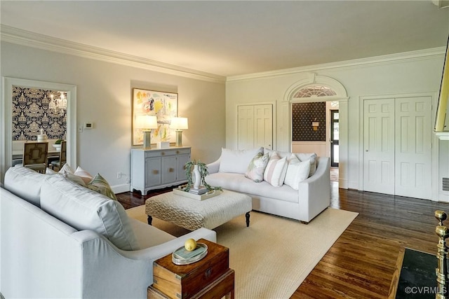 living area with dark wood-type flooring, ornamental molding, and baseboards