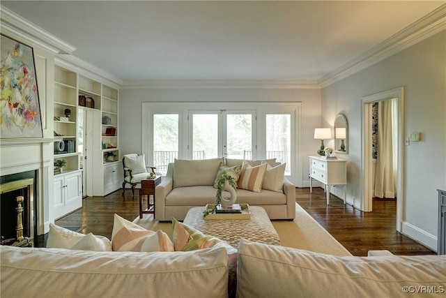 living room featuring french doors, crown molding, a fireplace, wood finished floors, and baseboards