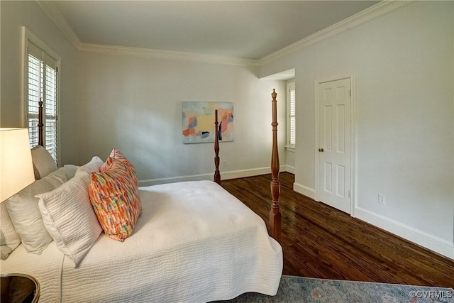 bedroom with baseboards, ornamental molding, and wood finished floors