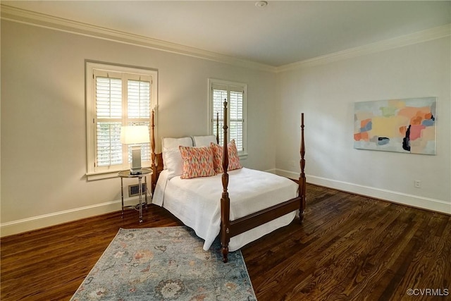 bedroom featuring baseboards, ornamental molding, and wood finished floors