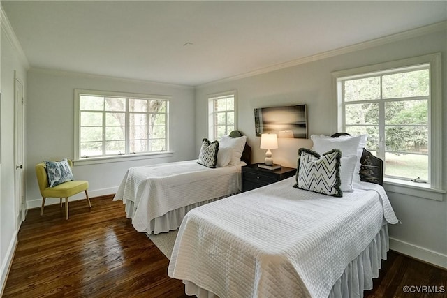 bedroom with crown molding, baseboards, and dark wood-style flooring