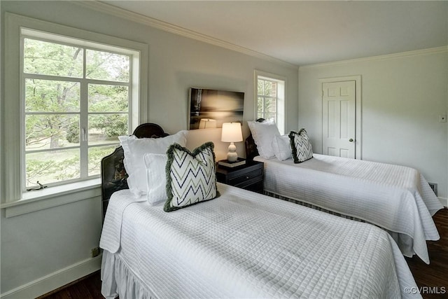 bedroom featuring crown molding, baseboards, and dark wood finished floors