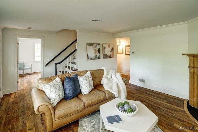 living area featuring crown molding, stairs, baseboards, wood finished floors, and visible vents