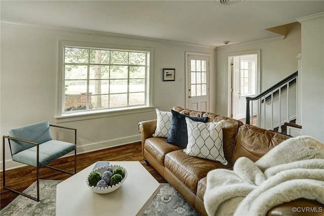 living area with crown molding, stairs, baseboards, and wood finished floors