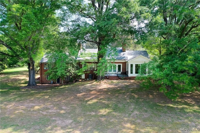 exterior space with brick siding and french doors