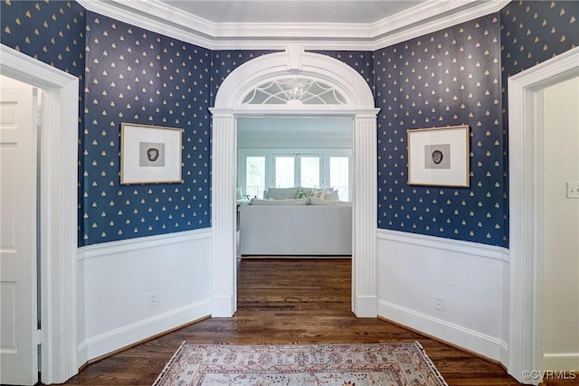 hall with baseboards, ornamental molding, wallpapered walls, and wood finished floors