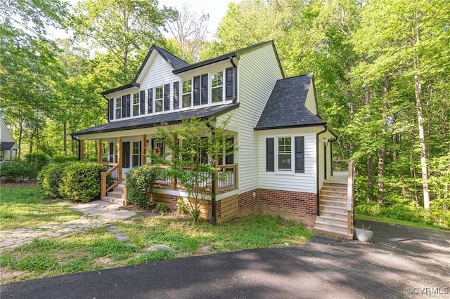 view of front of property featuring a porch and a shingled roof