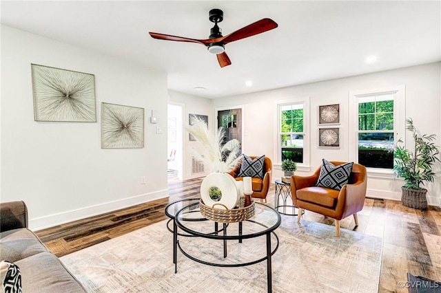 living area with baseboards, a ceiling fan, wood finished floors, and recessed lighting