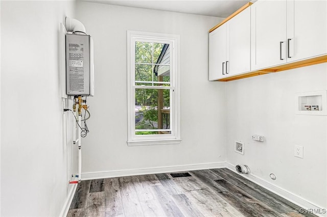laundry room featuring cabinet space, washer hookup, wood finished floors, and gas dryer hookup