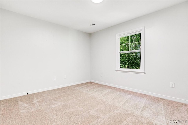 carpeted empty room with baseboards and visible vents