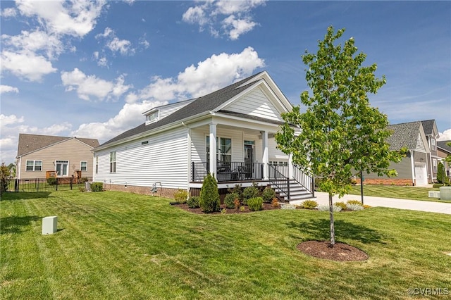 view of front of property with a porch, fence, and a front yard