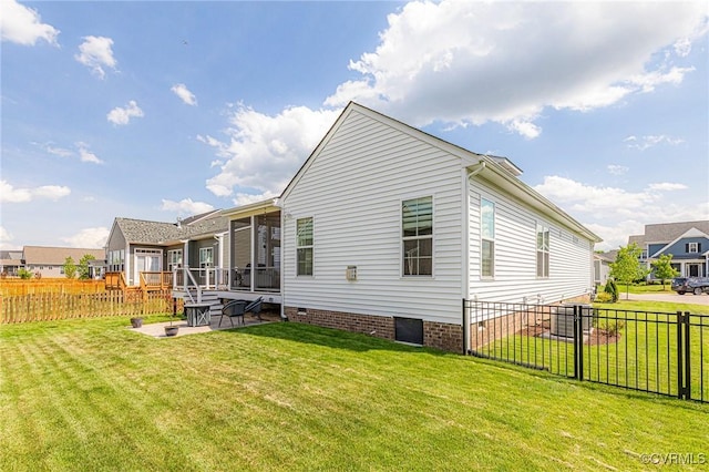 rear view of house featuring a patio, a yard, fence private yard, and crawl space