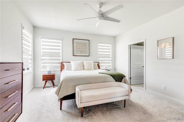 bedroom with light colored carpet and multiple windows