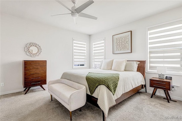 bedroom with baseboards, light carpet, and ceiling fan