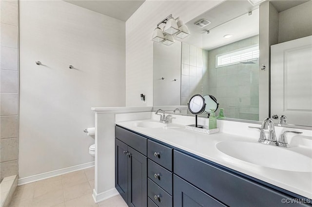 full bathroom featuring baseboards, a sink, double vanity, and tiled shower