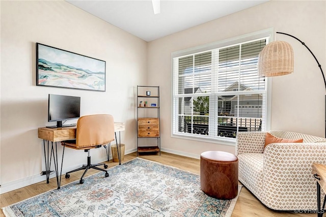 office with baseboards and wood finished floors