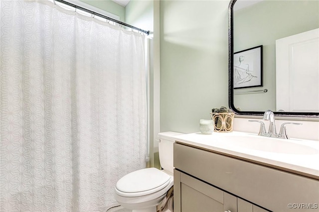 bathroom featuring vanity, a shower with curtain, and toilet