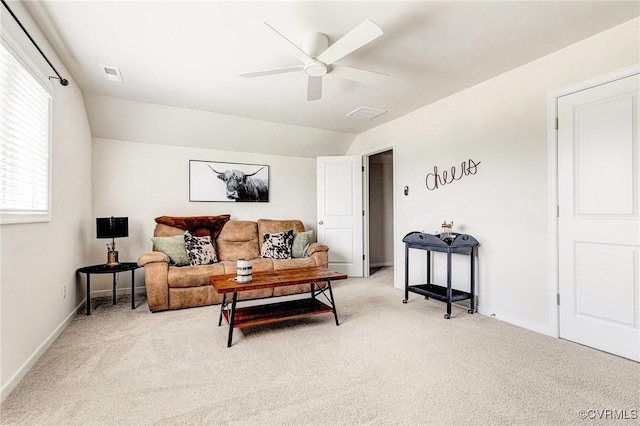 living room featuring a ceiling fan, baseboards, visible vents, and light carpet