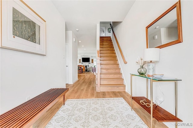 stairs with recessed lighting and wood finished floors